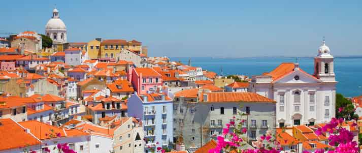 A view of Alfama in Lisbon, Portugal with the sea in the distance 