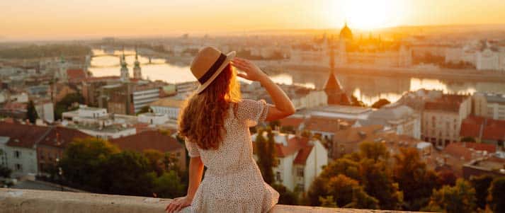 A woman watching the sunset from Fisherman's Bastion in Budapest, Hungary 