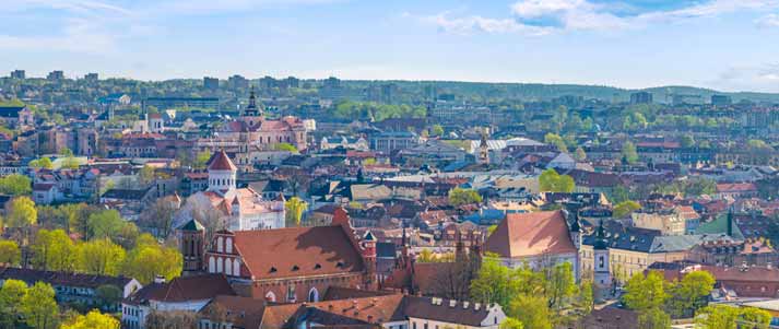 Panoramic view of Vilnius Old Town with lots of greenery and blue skies