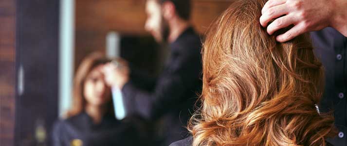 hairdresser styling a woman's hair