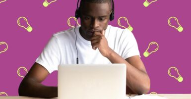 man studying at laptop with lightbulb background