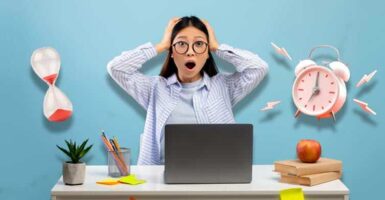 stressed student with laptop, hourglass and alarm clock